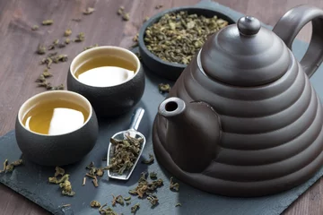 Foto op Aluminium teapot and cups with green tea, selective focus © cook_inspire