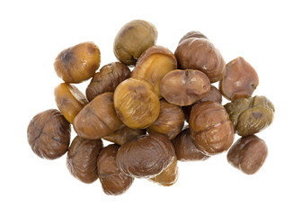 Organic whole shelled roasted chestnuts on a white background top view.
