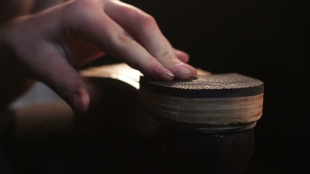 Bonding heel for men shoes. Shoemaker sews shoes. Hammering