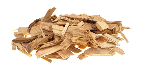 Small pile of hickory smoking chips for barbecue isolated on a white background.