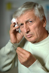 Sick old man on grey