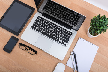 Top view open laptop with digital tablet and white smartphone