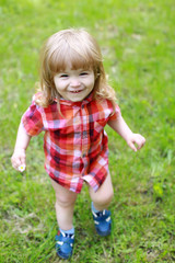 happy small boy on green grass