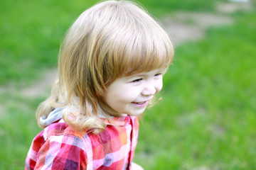 happy small boy on green grass