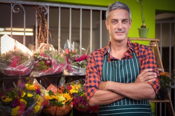 Male florist with arms crossed at flower shop