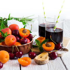 Ceramic bowl with organic ripe apricots and cherries