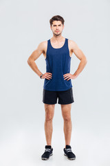 Obraz premium Full length portrait of sportsman standing with hands on hips