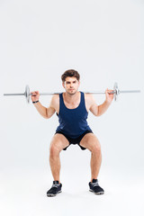 Muscular fitness man doing heavy exercise using barbell