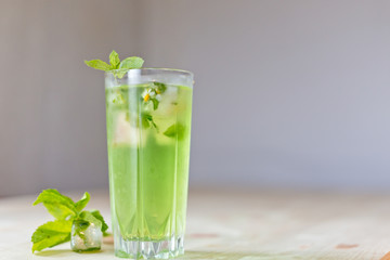 homemade refreshing summer cocktails with ice and mint on wooden cutting Board