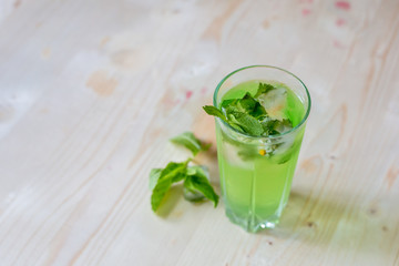 homemade refreshing summer cocktails with ice and mint on wooden cutting Board