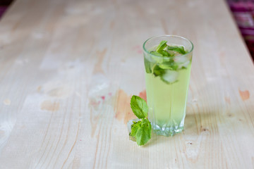 homemade refreshing summer cocktails with ice and mint on wooden cutting Board