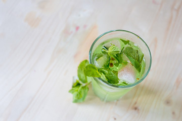 homemade refreshing summer cocktails with ice and mint on wooden cutting Board