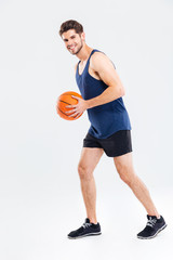 Full length portrait of a sports man playing in basketball