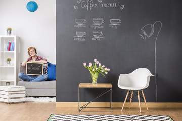 Creative ginger woman relaxing in her stylish flat