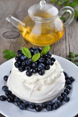 Pavlova cake with blueberries decorated with mint
