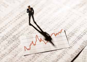 Banker schaut auf ein Diagramm mit Aktienkursen