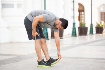 Man stretching before working out outdoors