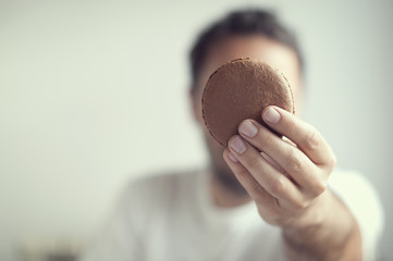 Hombre sujetando macaron