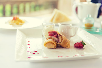 close up of pancakes and honey or jam on plate