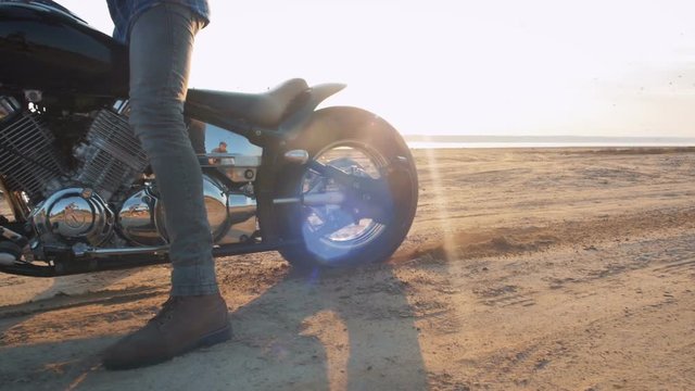 Motorcyclist doing tire burnout in the desert, slow motion