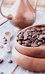 roasted coffee beans in wooden bowl, selective focus
