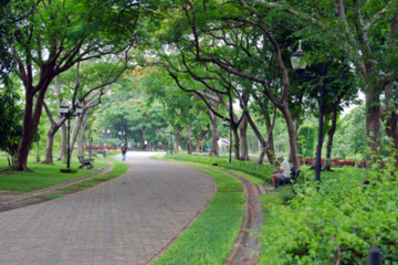 Blurred view of park and garden with people relaxing