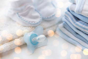 close up of soother and baby clothes for newborn