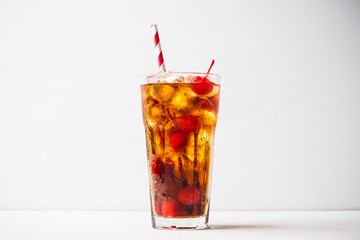 Refreshing cold cherry cola on the wooden background