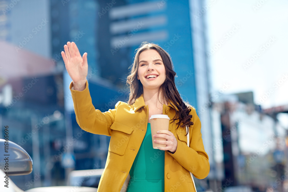 Poster happy young woman drinking coffee on city street