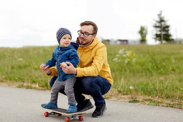 happy father and little son on skateboard