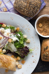 Homemade Chicken Caesar Salad with Cheese and Croutons, top view.