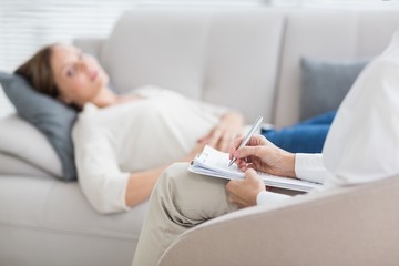 Therapist writing notes of patient