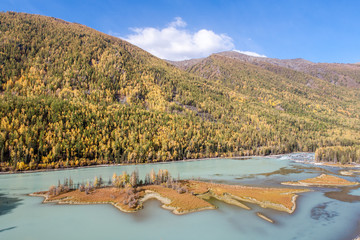 kanas lake in autumn with crystal blue water. Green trees. The natural beauty of the paradise. Kanas Nature Reserve. Xinjiang Province, China.