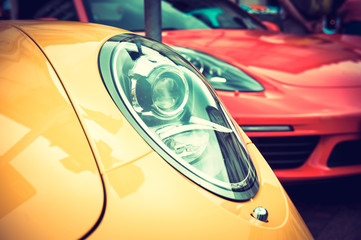 Close up of a yellow sport car: headlights