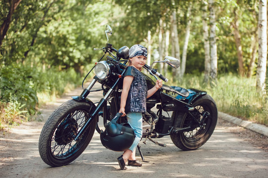 Little girl on a motorcycle.