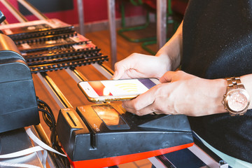 Mobile payment.Women use mobile to pay for goods.
