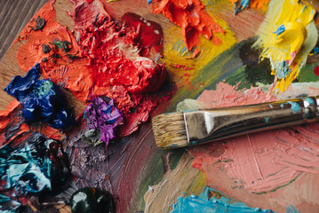Closeup of paint mixing process in art workplace.