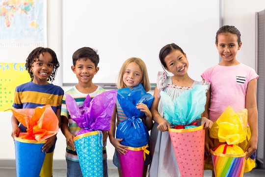 Smiling Multi Ethnic Children Holding Artwork 