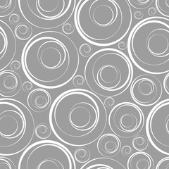 Seamless background. Rings of different sizes on a dark background.