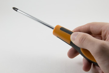 Screwdriver in hand on a white background