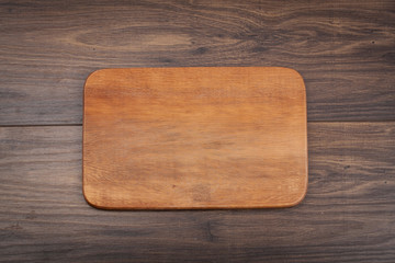 Empty vintage cutting board on planks food background concept
