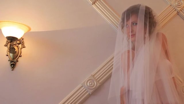 Beautiful bride relaxes and have fun in dressing room before wedding