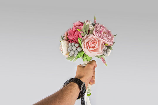 male hand giving wedding bouquet