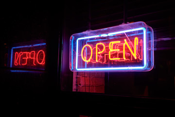 neon open sign welcomes customers into the restaurant