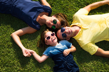 Family Lying On Grass In Countryside