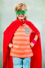 Boy dressed as superhero standing in classroom - obrazy, fototapety, plakaty