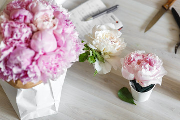Bouquet of peonies in kraft paper bag