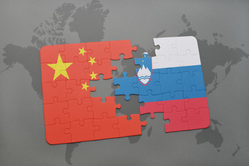 puzzle with the national flag of china and slovenia on a world map background.