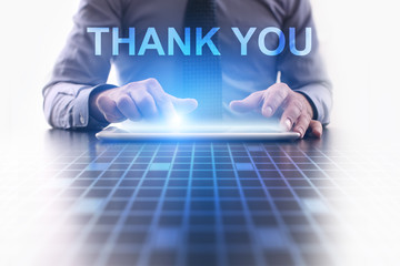 Businessman is pressing button on tablet pc and selecting Thank You. 