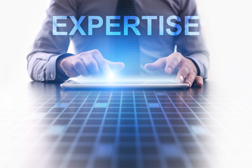 Businessman is pressing button on tablet pc and selecting Expertise.